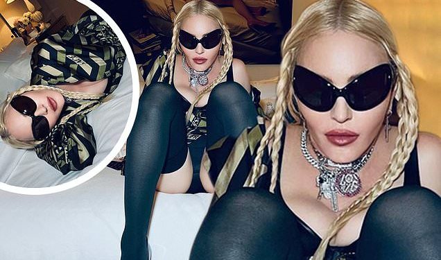 madonna-puts-on-a-smoldering-and-leggy-display-as-she-stretches-out-on-a-bed-in-new-…