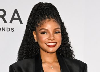 halle-bailey-hides-her-stomach-under-table-and-baggy-t-shirt-as-she-indulges-in-big-…